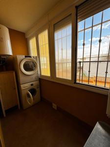 a kitchen with a washing machine and a window at Apartamento en Cartagena in Cartagena