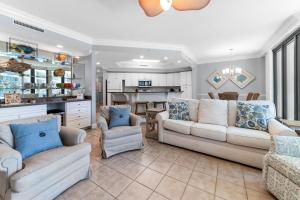 Una sala de estar con dos sofás y una cocina. en Phoenix On The Bay 1225 by Liquid Life, en Orange Beach