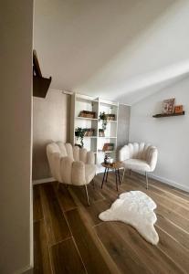 a living room with two chairs and a table at Casa Familia Jahorina in Jahorina