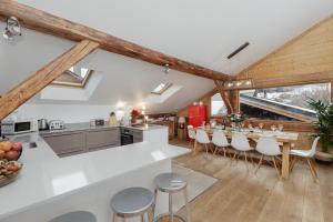 an open kitchen and dining room with wooden beams at Chalet Vogue in Morzine