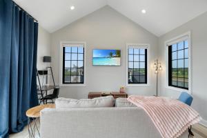 a living room with a couch and windows at Rooftop Retreat in Ottawa