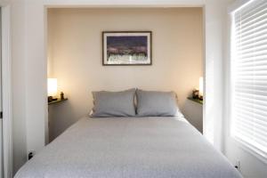a bedroom with a bed with two pillows at Woodchuck Flat in Fort Bragg