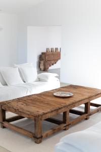 a wooden coffee table in a living room with a couch at Alàpega, Live Slow in Santa Susana