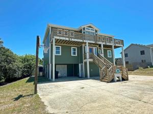 a house with a basketball hoop in front of it at KH4508- Surf Par-Tee in Kitty Hawk