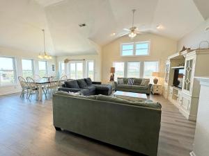 a living room with a couch and a table at KH4508- Surf Par-Tee in Kitty Hawk