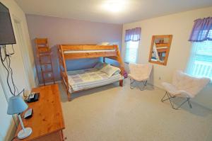 a bedroom with a bunk bed and two chairs at KH4508- Surf Par-Tee in Kitty Hawk +25 photos