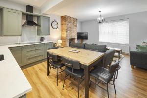 a kitchen and living room with a table and chairs at Host & Stay - Cedar Cottage in Belford