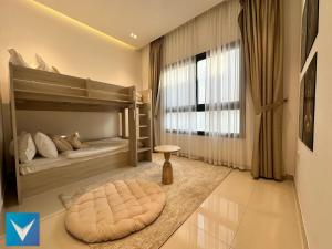 a bedroom with bunk beds and a large window at 3BR Modern Seashore Private Villa with swimming Pool in Fujairah +44 photos