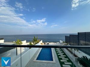 a view of the ocean from the balcony of a building at 3BR Modern Seashore Private Villa with swimming Pool in Fujairah