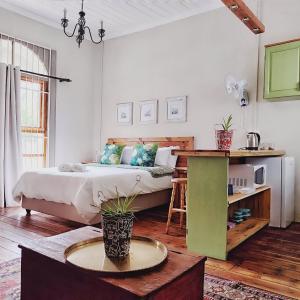 a bedroom with a bed and a table in it at The Writer's House Cottages in Bedford