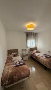two beds sitting in a room with a light at F10 - Vila D Orpesa X, World Lujo - ServHouse in El Borseral +40 photos