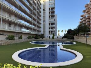 an empty swimming pool in the middle of a building at F10 - Vila D Orpesa X, World Lujo - ServHouse in El Borseral
