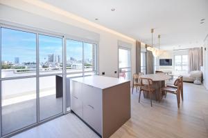a kitchen and dining room with a view of the city at Allenby 36 Bauhaus Residence 5 Stars in Tel Aviv