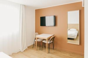 a small room with a table and a mirror at Miranove in Montpellier