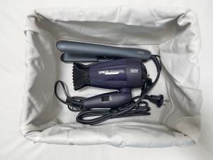 a hair dryer and a blow dryer with a cord at Busan Vacance Stay, cozy house in Busan