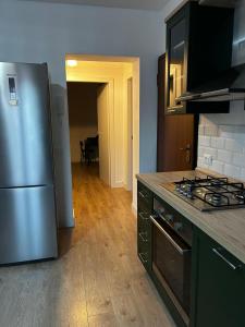 a kitchen with a stainless steel refrigerator and a stove at Via De'Amicis in Certaldo