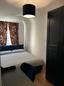a small bedroom with a bed and a window at Via De'Amicis in Certaldo