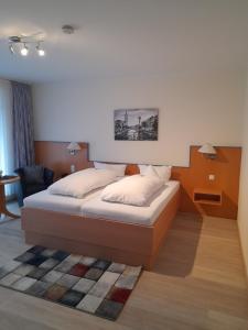 a bedroom with a bed in a room at Hotel Diekgerdes, in Cloppenburg