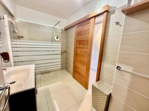 a bathroom with a sink and a shower at STUDIO DU MUSEE in Saint-François +37 photos