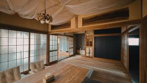 a living room with a table and some windows at Eastern sunrise home Valuable historical Japanese-style exclusive 4mins to ocean in Choshi +53 photos