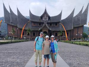 a group of people standing in front of a building at Hasbi Homestay Syariah in Bukittinggi