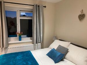 a small bedroom with a bed and a window at Ty Bach Melyn, car parking and private courtyard in Bridgend