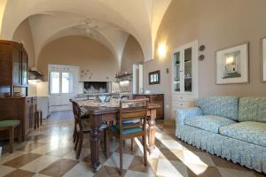 a kitchen and living room with a table and a couch at Country pool house in Casarano