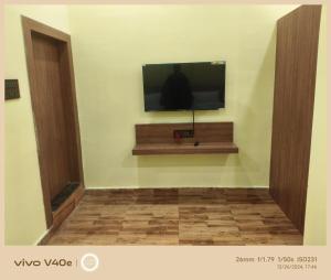 a flat screen tv on a wall in a room at The Grand Inn Resort in Dum Duma