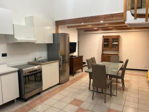 a kitchen with a table and a dining room at Residence La Lanterna in Genoa