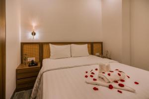 Postel nebo postele na pokoji v ubytování De V’Charm Hotel