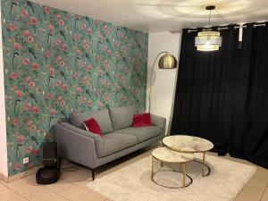 a living room with a couch and a table at La Gravelinoise in Gravelines