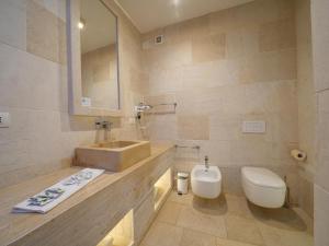 a bathroom with a sink and a toilet at HOTEL BARONE DI MARE in Torre dell'Orso