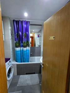 a bathroom with a shower curtain with a tub and a toilet at APARTMAN LIDER Zagreb Free Parking 2 Bedrooms 54 m2 Self Check-in in Zagreb +60 photos