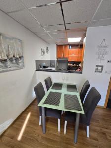 a table and chairs in a room with a kitchen at APARTMAN LIDER Zagreb Free Parking 2 Bedrooms 54 m2 Self Check-in in Zagreb