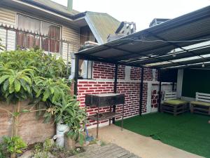 a patio with a grill and a brick house at Casa Alameda Remodelada in Constitución +2 photos