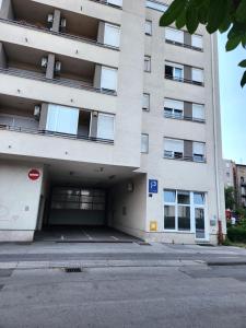 an empty parking lot in front of a building at APARTMAN LIDER Zagreb Free Parking 2 Bedrooms 54 m2 Self Check-in in Zagreb