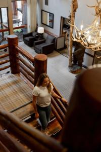 a woman walking down the stairs of a house at The Lodge at Jackson Hole in Jackson