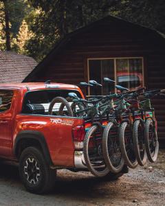 a red truck with a row of bikes on the back at The Lodge at Jackson Hole in Jackson