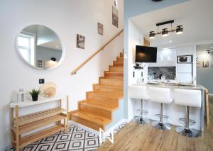a living room with a staircase and a mirror at Mystay - Riverview House in Porto