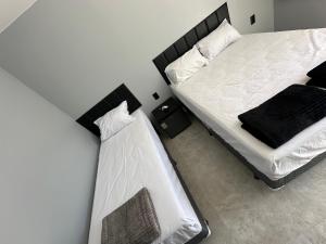 Postel nebo postele na pokoji v ubytování Uniq suítes Japaratinga