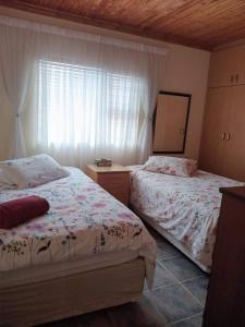 a bedroom with two beds and a window at Paresis 7 in Hentiesbaai