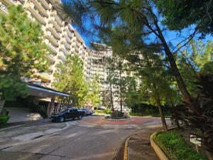a street with a car parked in front of a building at Cloud Studio at Northpoint in Davao City