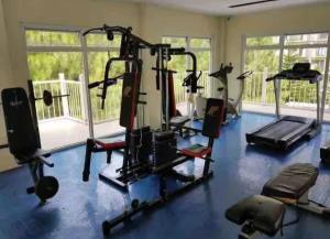 a gym with several tread machines in a room at Cloud Studio at Northpoint in Davao City