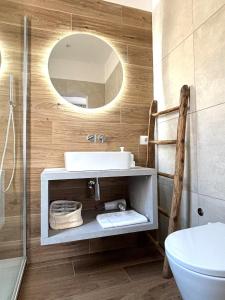 a bathroom with a sink and a mirror at M4 WHITE Monolocale Moderno e Funzionale in Scandicci