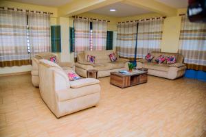 a living room with two couches and a coffee table at Centre Missionnaire Lavigerie in Kigali