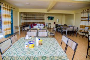 a dining room with a table and chairs and tables and chairsktop at Centre Missionnaire Lavigerie in Kigali