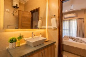 a bathroom with a sink and a mirror at Alaya Stays 3 BHK Veera Marina Pentahouse with Pool & Lift in Candolim