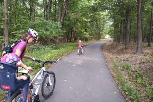 a woman and a child riding bikes on a trail at Lazy in Tiny in Hrušov