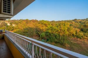 a balcony with a view of a forest at Alaya Stays 3 BHK Veera Marina Pentahouse with Pool & Lift in Candolim