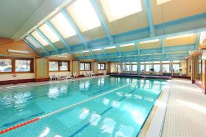 a large indoor swimming pool with a large swimming pool at Mondzeu C261 in Bagnes